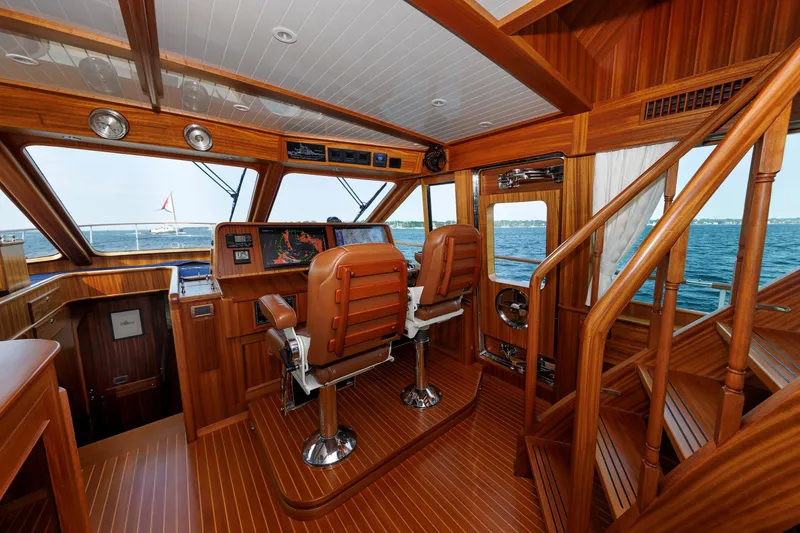 Slide: The Image of Pilothouse interior of 2016 Hunt Yachts 72 FB, featuring luxurious wood finish and ocean view. - 23