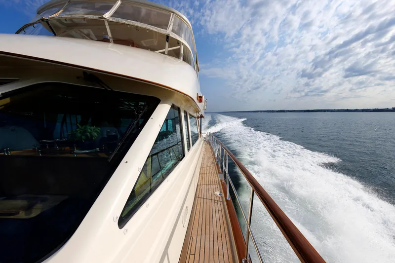 Slide: The Image of 2016 Hunt Yachts 72 FB cruising on open water under a partly cloudy sky. - 61
