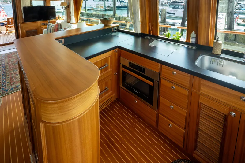 Slide: The Image of Luxurious kitchen interior of 2016 Hunt Yachts Ocean Series 72FB with wood cabinetry and modern appliances. - 16