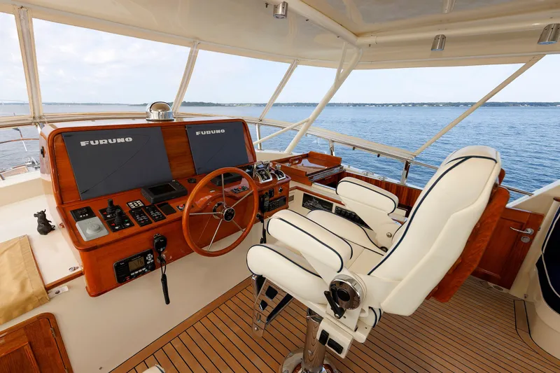 Slide: The Image of Helm of 2016 Hunt Yachts 72 FB with navigation equipment and captain's chair. - 51