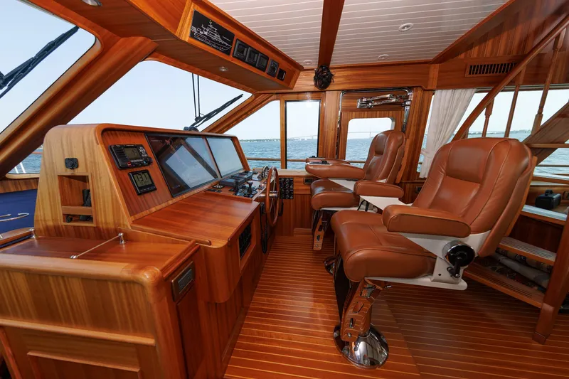 Slide: The Image of Luxurious helm of 2016 Hunt Yachts 72 FB with leather seats and wooden interior. - 19