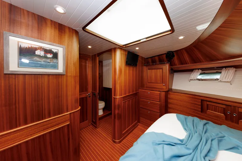 Slide: The Image of Luxurious 2016 Hunt Yachts 72 FB cabin interior with wood paneling and cozy bedding. - 40