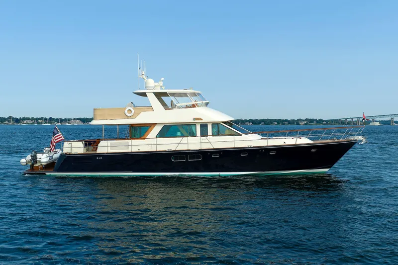 Slide: The Image of 2016 Hunt Yachts 72 FB cruising on open water under clear blue sky. - 77