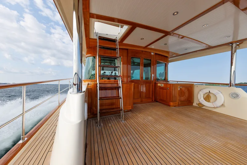 Slide: The Image of Luxurious 2016 Hunt Yachts 72 FB deck with wooden finish and ocean view. - 46