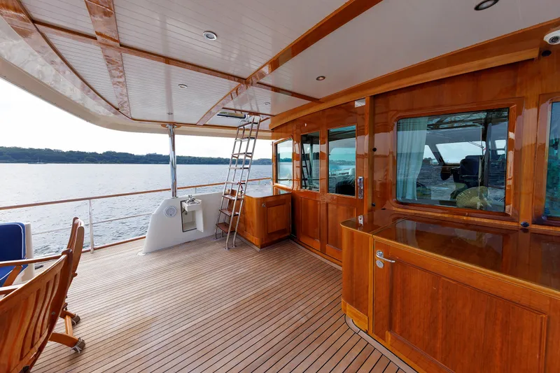 Slide: The Image of Luxurious 2016 Hunt Yachts 72 FB deck with wooden finish and ocean view. - 6