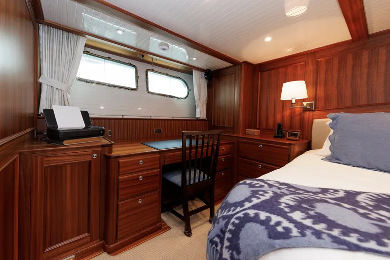 Slide: The Image of Luxurious cabin interior of 2016 Hunt Yachts 72 FB with wood paneling and cozy bedding. - 29