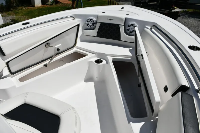 Slide: The Image of 2023 Tidewater 210 LXF boat interior with open storage compartments and speakers. - 10
