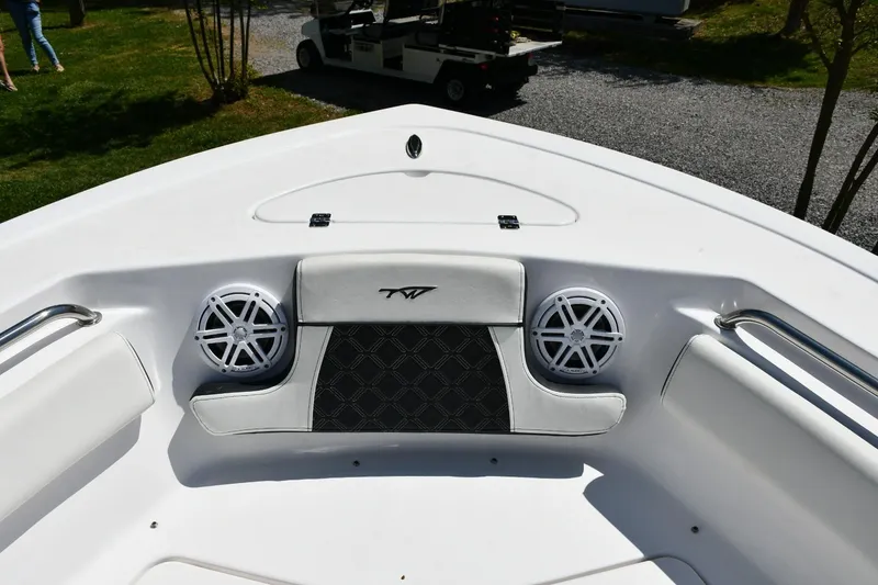 Slide: The Image of 2023 Tidewater 210 LXF boat bow with speakers and cushioned seating. - 7