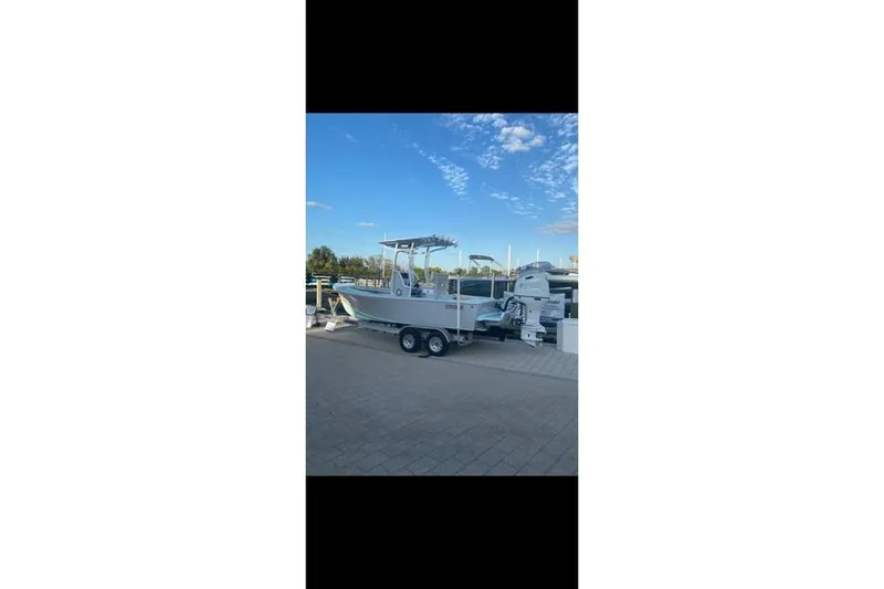 Slide: The Image of 2026 Exuma 22 boat on trailer, parked outdoors under a clear blue sky. - 6