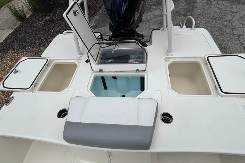 Slide: The Image of 2026 Mako 18 Pro Skiff boat deck with storage compartments and seating. - 7