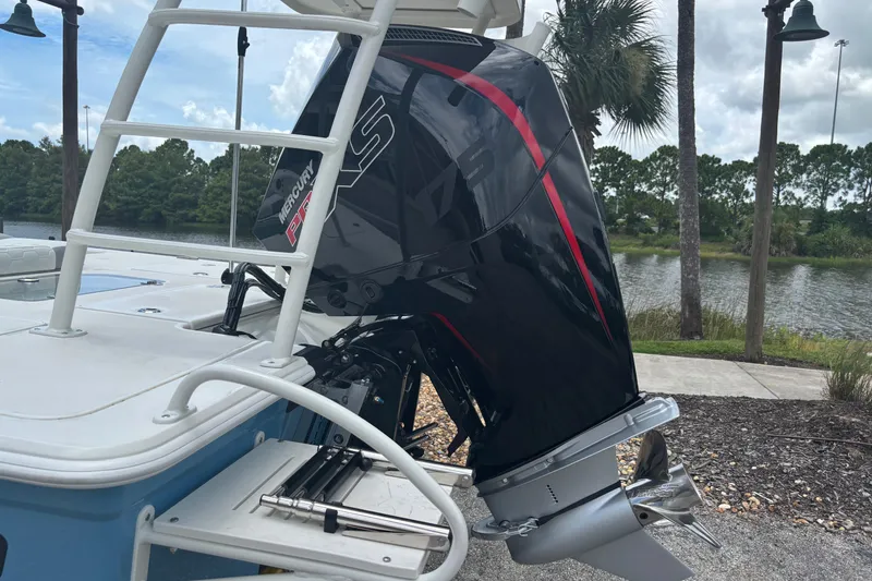 Slide: The Image of 2026 Mako 18 Pro Skiff with Mercury outboard motor by a scenic lakeside. - 11