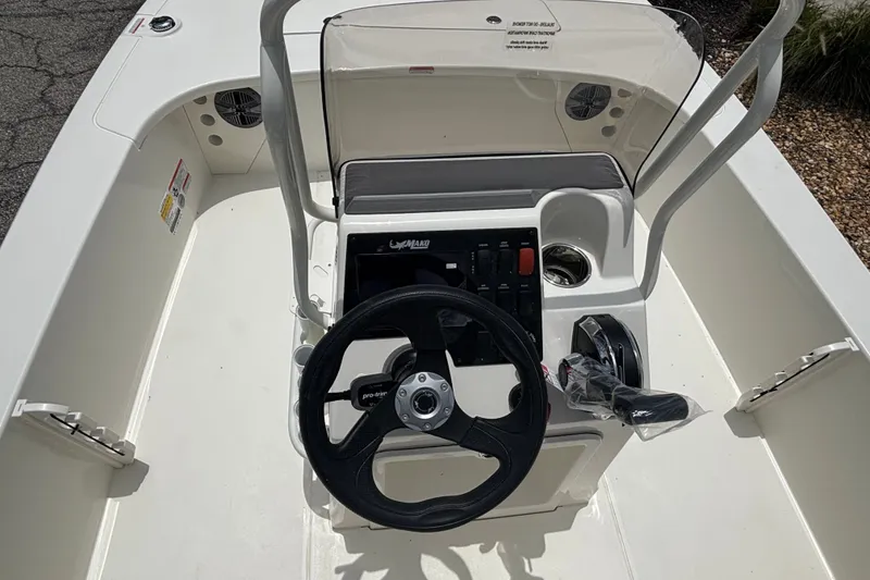 Slide: The Image of 2026 Mako 18 Pro Skiff boat console with steering wheel and controls. - 9