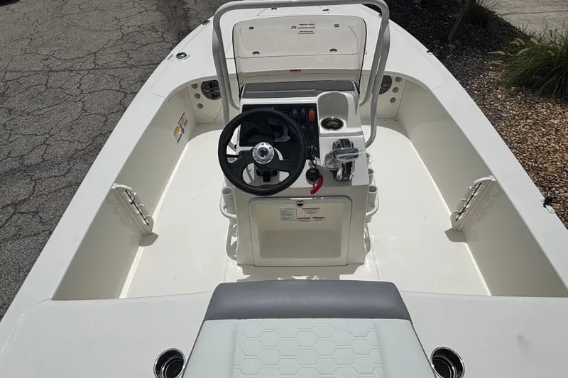 Slide: The Image of 2026 Mako 18 Pro Skiff boat interior with steering console and seating. - 52
