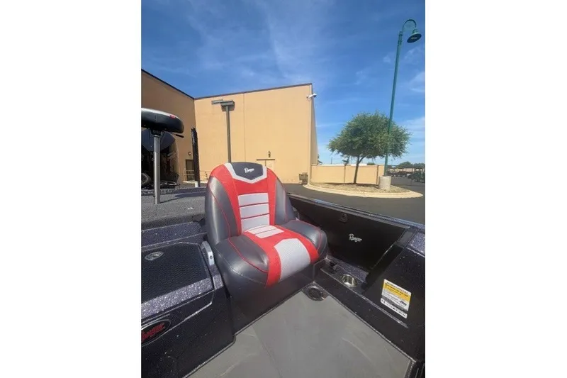 Slide: The Image of 2026 Ranger Z521 boat seat with red and gray design, outdoor setting. - 8