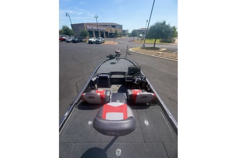 Slide: The Image of 2026 Ranger Z521 boat interior with red and gray seating at a service center. - 6