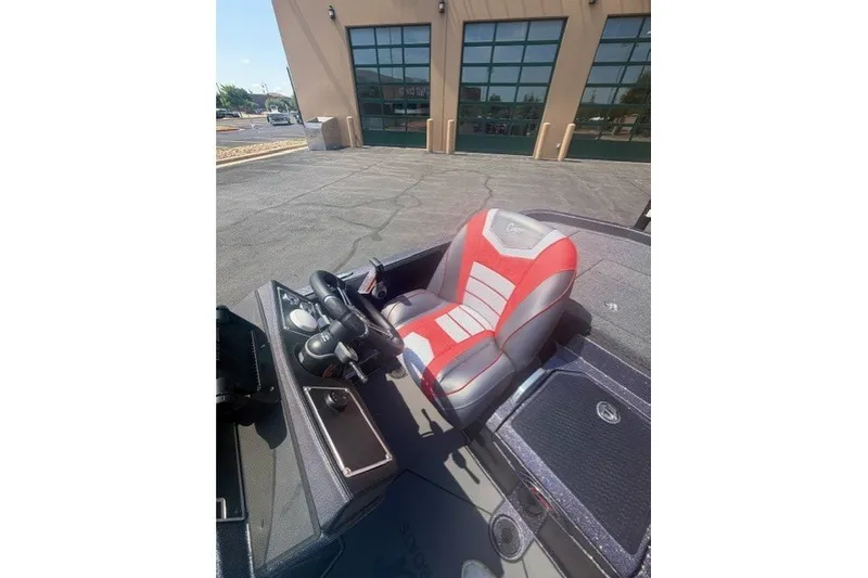 Slide: The Image of 2026 Ranger Z521 boat interior with red and gray seating, steering wheel, and dashboard. - 7