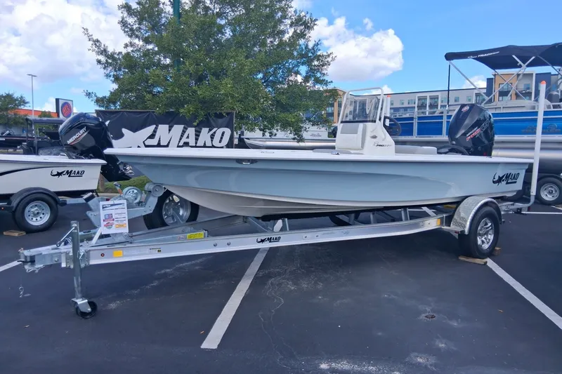The Image of 2026 Mako 18 Pro Skiff boat on trailer in parking lot, displayed outdoors. - 0