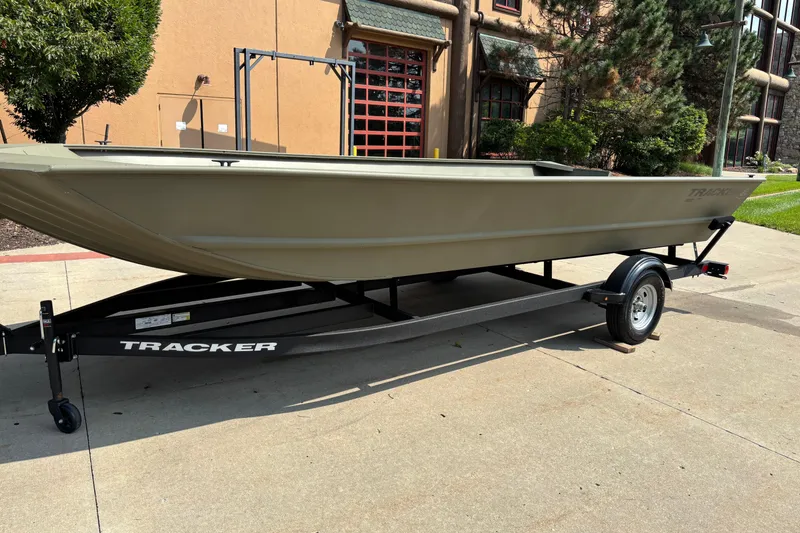 Slide: The Image of 2026 Tracker Grizzly 2072 Utility boat on trailer, parked outdoors. - 3