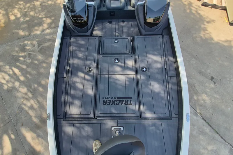 Slide: The Image of 2026 Tracker Savage 215 boat deck with storage compartments and dual engines. - 13
