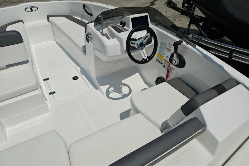 Slide: The Image of 2026 Tahoe T16 boat interior with steering wheel and seating arrangement. - 11