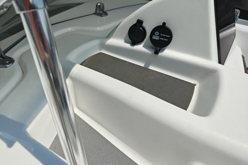 Slide: The Image of 2026 Tahoe T16 boat interior with audio and USB inputs, featuring sleek white design. - 15