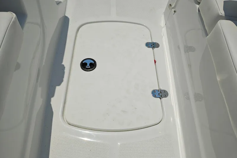Slide: The Image of 2026 Tahoe T16 boat storage compartment with secure latch and clean white finish. - 17