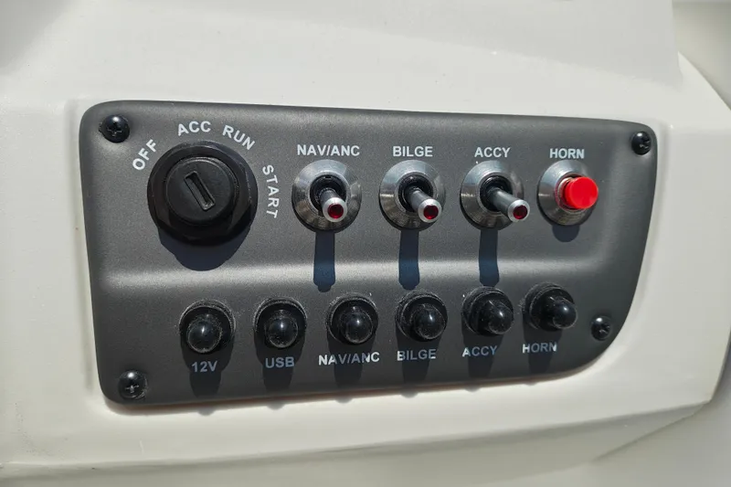 Slide: The Image of Control panel of 2026 Tahoe T16 boat with switches and ignition. - 13