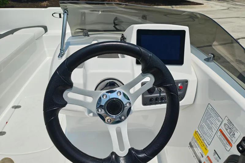 Slide: The Image of Steering console of 2026 Tahoe T16 boat with modern controls and display screen. - 12