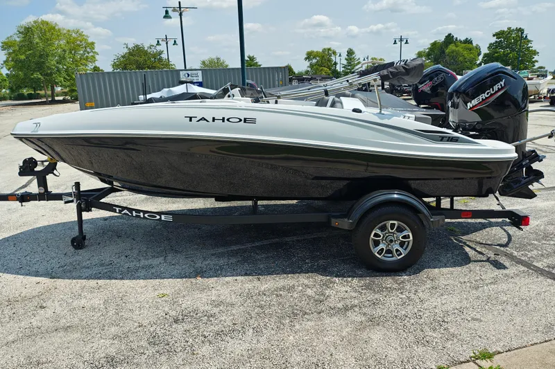 The Image of 2026 Tahoe T16 boat on trailer, featuring sleek design and Mercury outboard motor. - 0