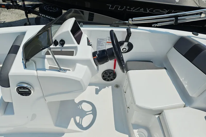 Slide: The Image of 2026 Tahoe T16 boat interior with steering wheel and seating area. - 7