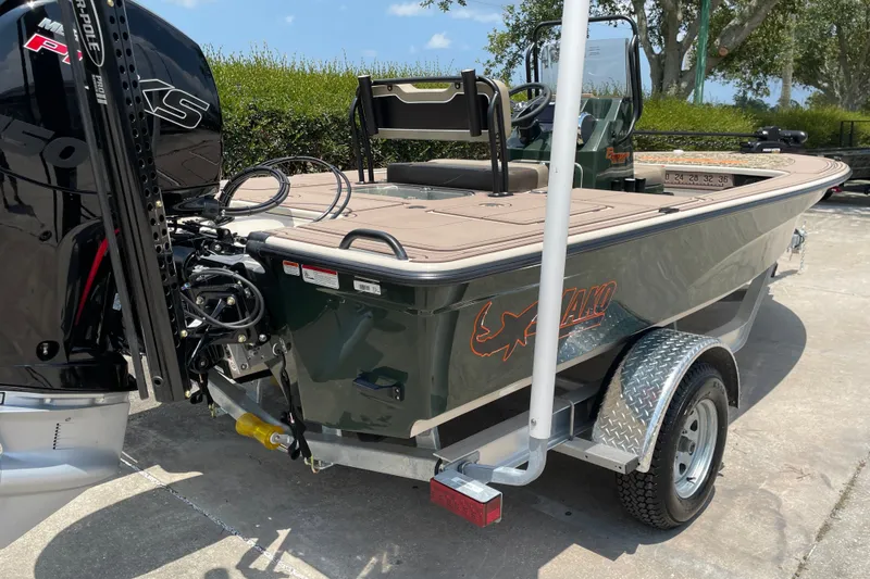 Slide: The Image of 2026 Mako 18 Pro Skiff Backwater Edition boat on trailer, featuring powerful outboard motor. - 5