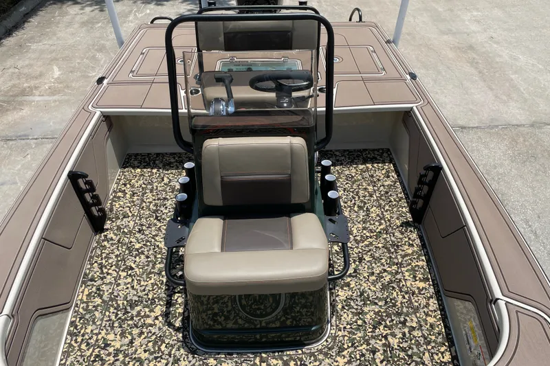 Slide: The Image of 2026 Mako 18 Pro Skiff Backwater Edition with camouflage flooring and beige seating. - 12