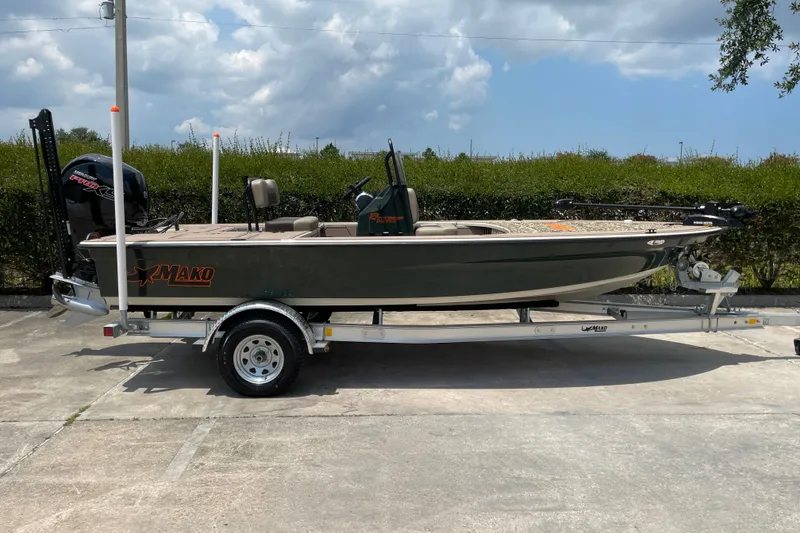 Slide: The Image of 2026 Mako 18 Pro Skiff Backwater Edition on trailer, parked outdoors under cloudy sky. - 4