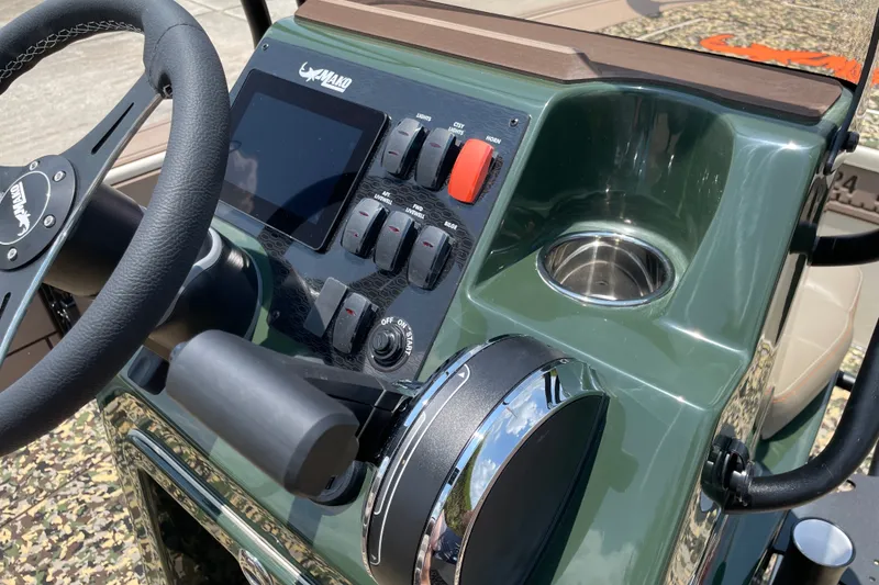 Slide: The Image of 2026 Mako 18 Pro Skiff Backwater Edition dashboard with steering wheel and control panel. - 11