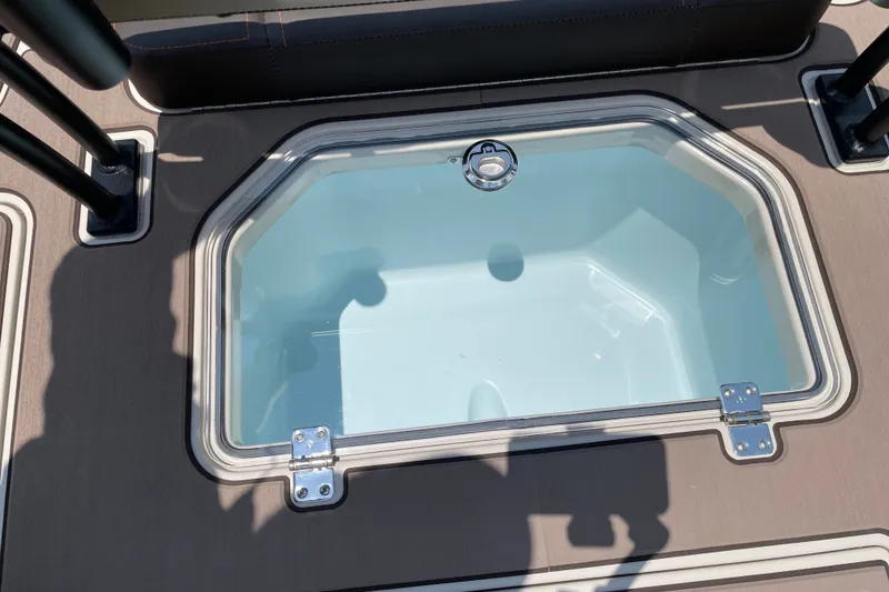 Slide: The Image of Livewell on 2026 Mako 18 Pro Skiff Backwater Edition boat, featuring a clear lid. - 14