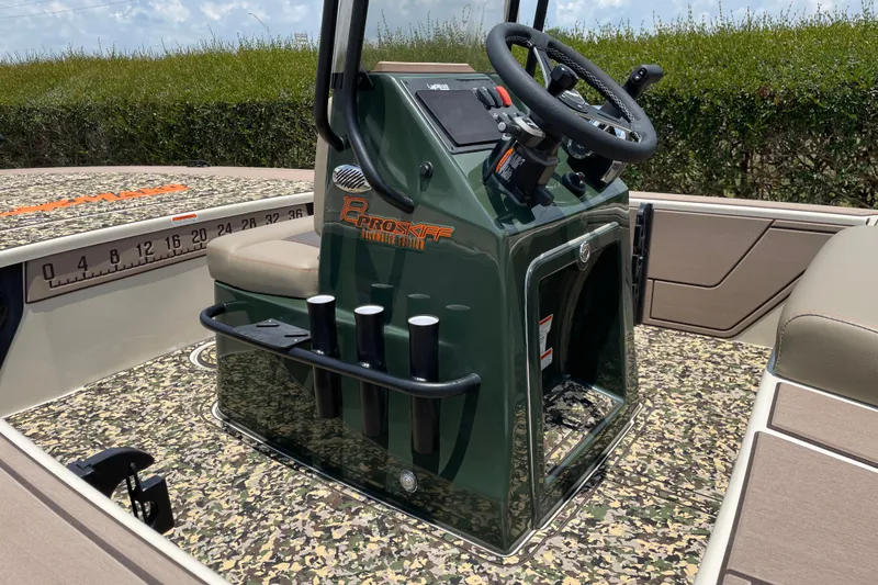 Slide: The Image of 2026 Mako 18 Pro Skiff Backwater Edition with camo deck and steering console. - 9