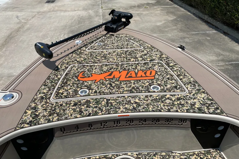 Slide: The Image of 2026 Mako 18 Pro Skiff Backwater Edition with camo design and trolling motor. - 13