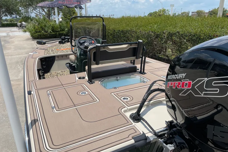 Slide: The Image of 2026 Mako 18 Pro Skiff Backwater Edition with Mercury Pro XS engine, docked outdoors. - 3