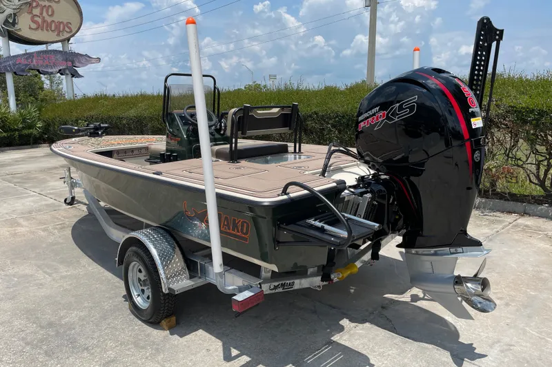 Slide: The Image of 2026 Mako 18 Pro Skiff Backwater Edition boat with Mercury Pro XS engine on trailer. - 2