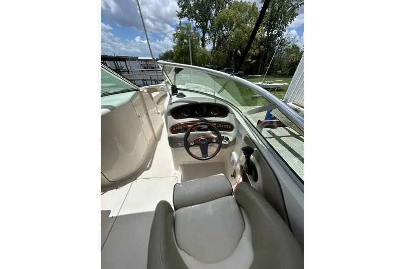 Slide: The Image of 2005 Sea Ray 270 Sundeck boat interior with steering wheel and dashboard controls. - 11
