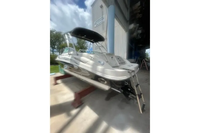Slide: The Image of 2005 Sea Ray 270 Sundeck boat on a lift, under a canopy, outdoors. - 5