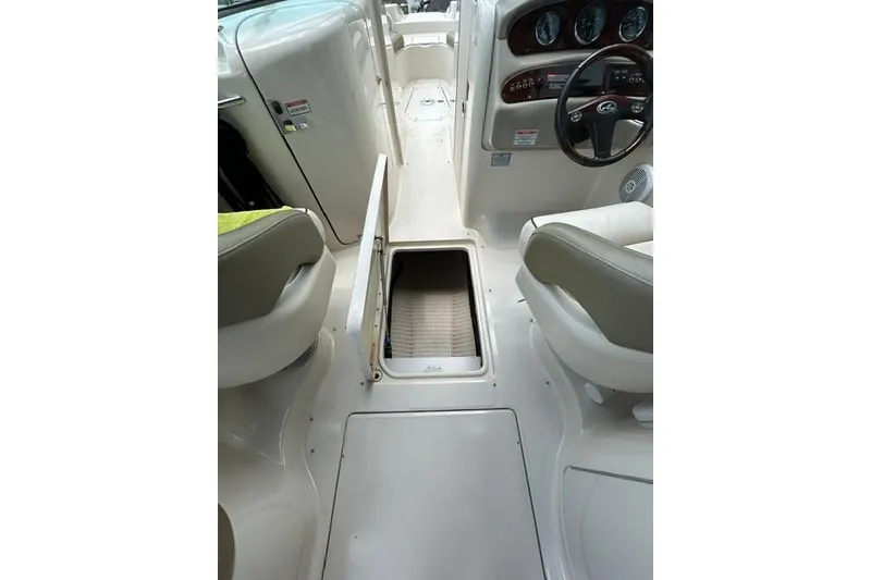 Slide: The Image of Interior view of a 2005 Sea Ray 270 Sundeck boat, featuring seating and storage. - 14