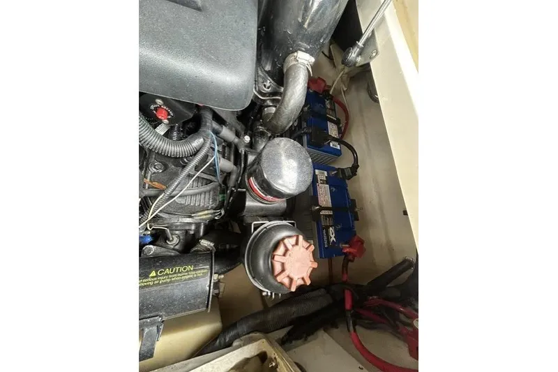 Slide: The Image of Engine compartment of a 2005 Sea Ray 270 Sundeck with visible components and wiring. - 10