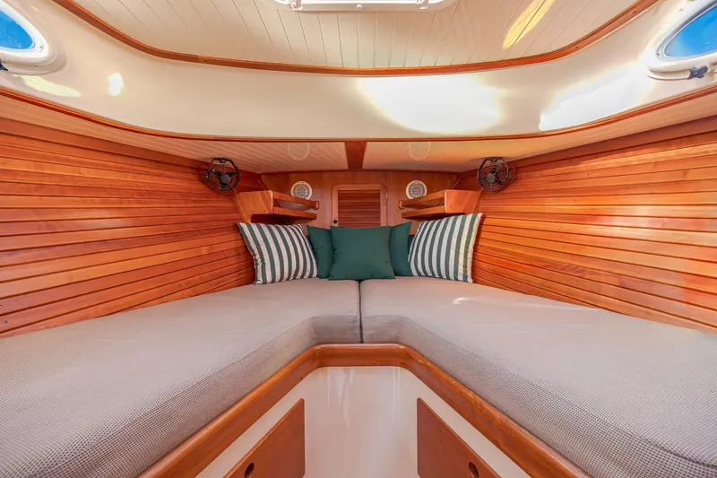 Slide: The Image of Interior of 2001 Hinckley Picnic Boat 36 Classic with cozy wooden cabin and cushions. - 33