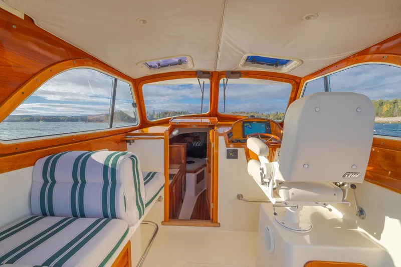 Slide: The Image of Interior of 2001 Hinckley Picnic Boat 36 Classic with striped seating and wooden accents. - 22