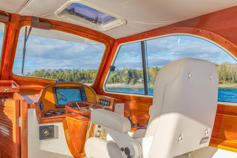 Slide: The Image of Interior of 2001 Hinckley Picnic Boat 36 Classic with wooden dashboard and navigation system. - 24