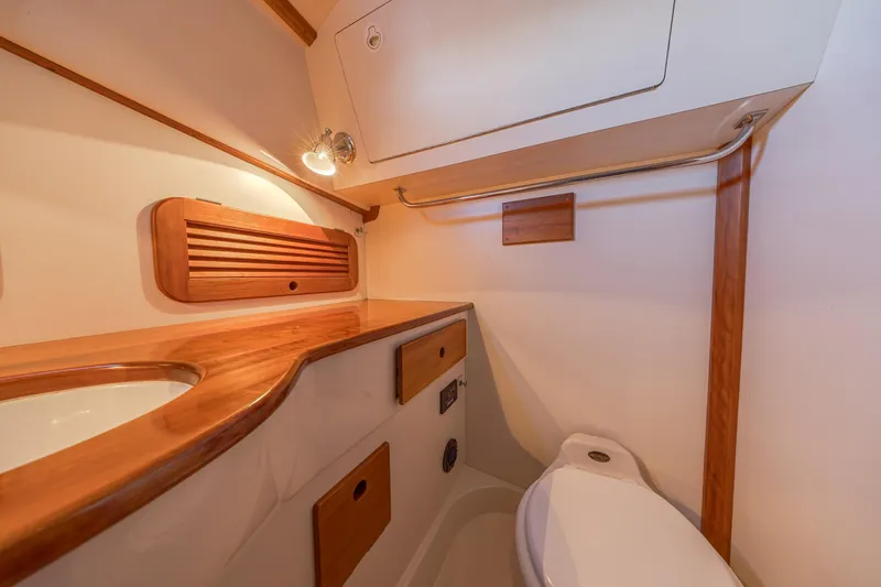 Slide: The Image of Hinckley Picnic Boat 36 Classic 2001 bathroom with wooden accents and modern fixtures. - 37