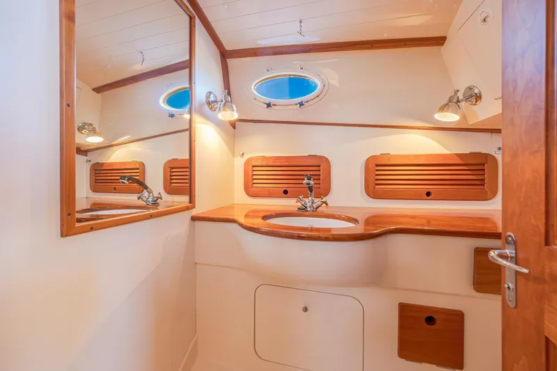 Slide: The Image of Elegant bathroom interior of 2001 Hinckley Picnic Boat 36 Classic with wooden accents. - 36
