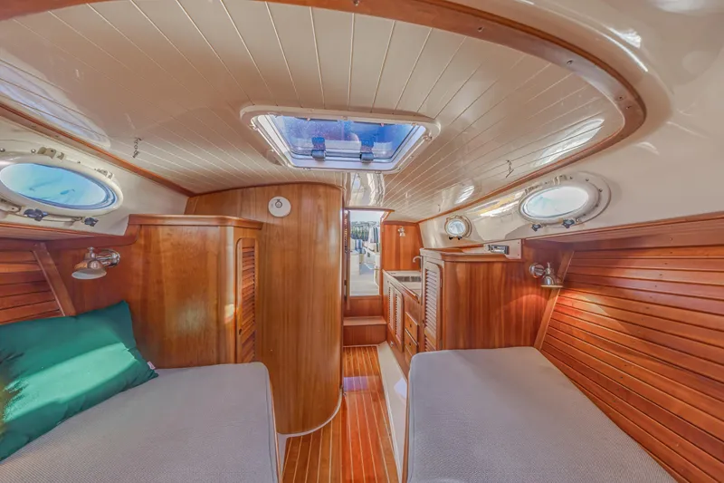 Slide: The Image of Interior of 2001 Hinckley Picnic Boat 36 Classic with wooden finishes and twin beds. - 35