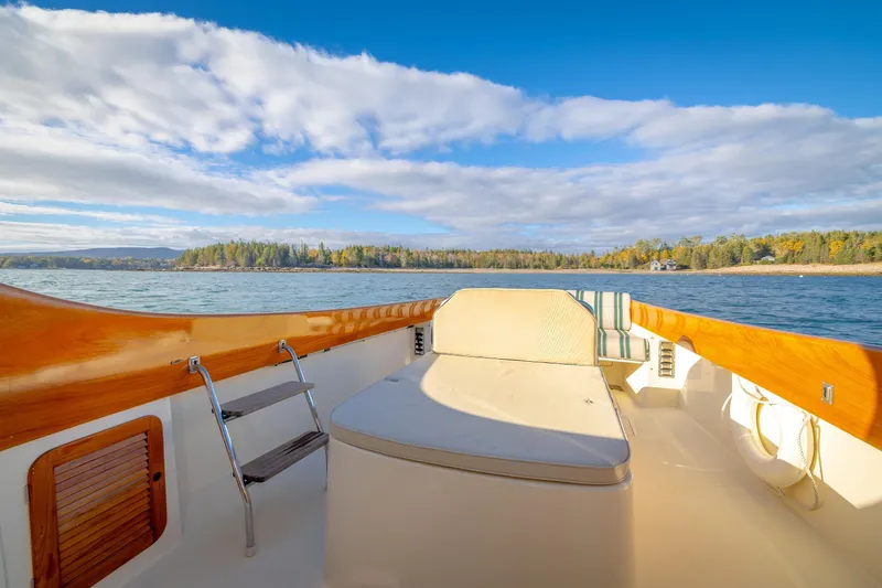 Slide: The Image of Hinckley Picnic Boat 36 Classic, 2001, cruising on serene waters under a blue sky. - 19
